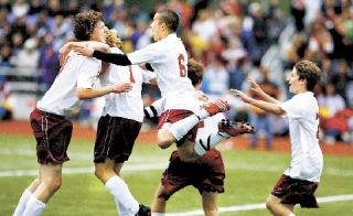 Kingston’s Josh Gilson launches himself to hug Chance Pruiett who’d just scored the Bucs first goal to tie the state playoff game against Anacortes 1-1. A slide show of Tuesday’s and today’s game can be seen online at www.northkitsapherald.com.