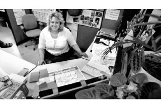 NKSD facilities coordinator Valerie Oas is surrounded by schedules as she coordinates more than 6