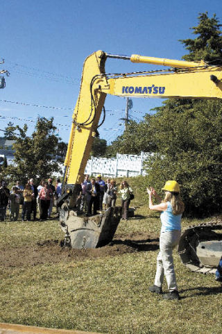 Poulsbo Mayor Kathryn Quade applauds as the dirt moves