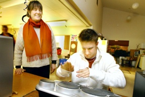 Glynis Burns watches as "Rock the Clock" host and emcee Cassidy Malone jams a number on an electronic drum during the evening activities. The event was conducted Saturday night at the Suquamish United Church of Christ.