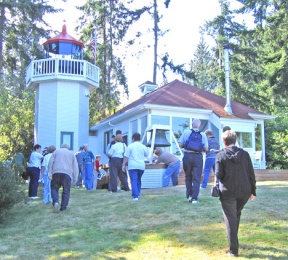 Members of the U.S. Lighthouse Society get a rare look at the privately owned Skunk Bay Lighthouse in Hansville as part of their tour of Puget Sound lighthouses last month. The lighthouse is not open to the public.