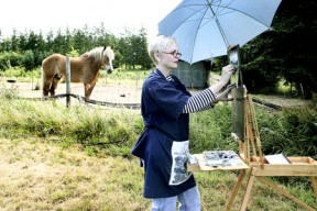 Left: Plein air artist Mary Stroeing paints under the watchful eye of an equine spectator while on a trip to Bainbridge Vineyards last week.