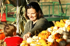 Valerie Johnson helps one year old son Griffin with a gourd selection at the Bainbridge Island Suyematsu Farm on Thursday. The farm has pumpkin picks