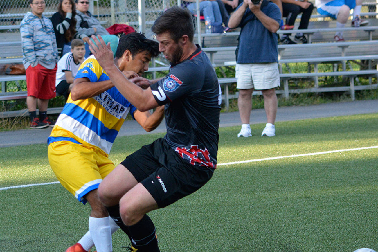 Kitsap SC’s Jorge Ruiz battles with FC Mulhouse Portland defender Joel Bagby during their playoff game on July 15.