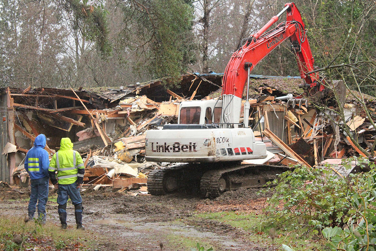 &lt;em&gt;City of Poulsbo workers stand by as an excavator demolishes the vacant house at Centennial Park.&lt;/em&gt;&lt;em&gt; &lt;/em&gt;Nick Twietmeyer/Kitsap News Group