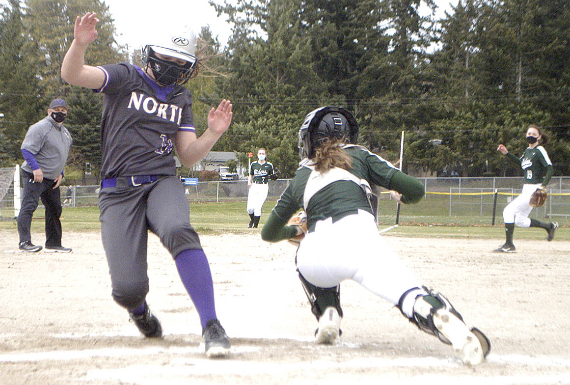 Kendall Becker of North Kitsap is safe at home ahead of the tag against Port Angeles. Pierre LaBossiere/For the North Kitsap Herald