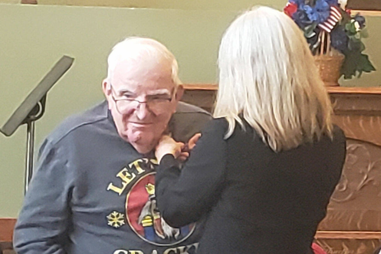 A veteran who lives at Brookdale Montclair in Poulsbo receives a pin for his years of military service. Tyler Shuey/Kitsap News Group Photos