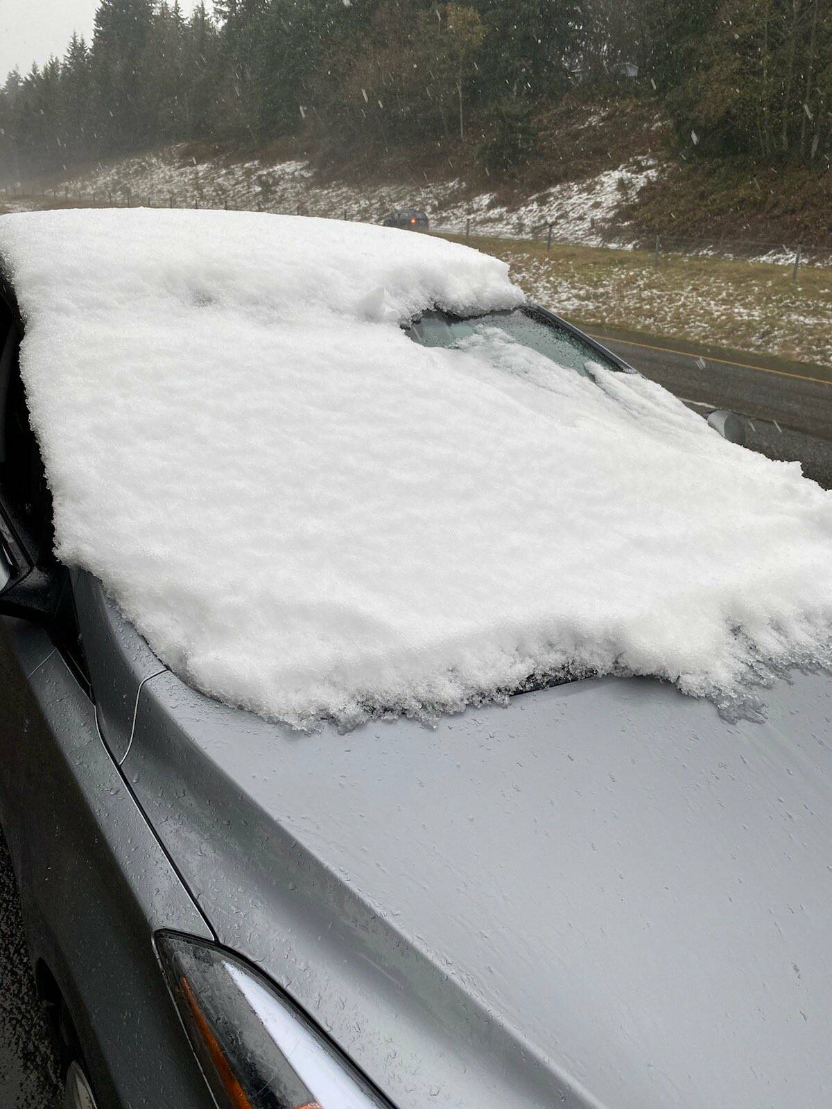 Aside from a small corner, the windshield and top of the car are packed with snow and ice. Courtesy Photo