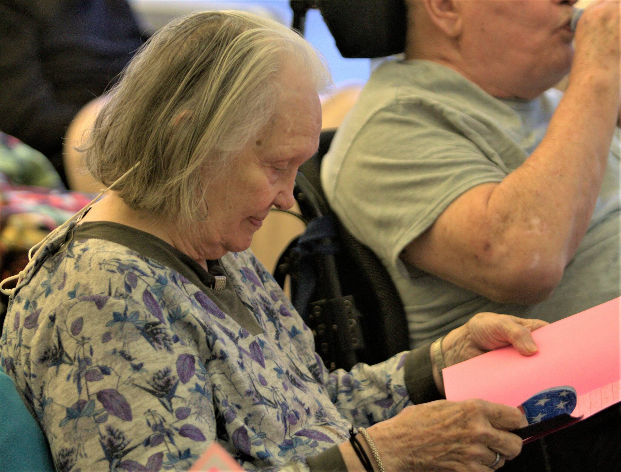 A resident at Washington Veterans Home opens her valentine to read a special message. Elisha Meyer/Kitsap News Group