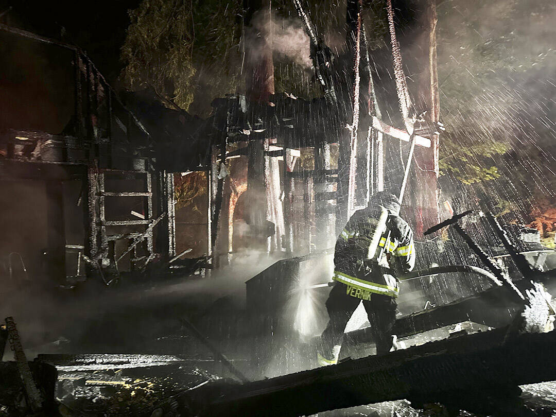 NKF&R courtesy photo
A firefighter fights the blaze between Kingston and Poulsbo early Sept. 4.