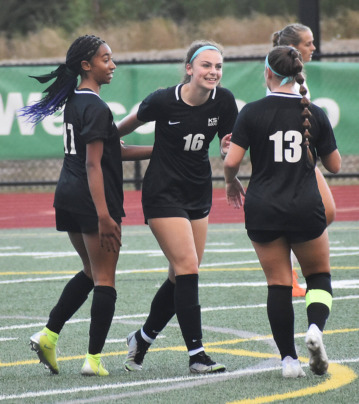 Nicholas Zeller-Singh/Kitsap News Group Photos
Addyson Dickey, Amira Lyons and Ali Divano celebrate a 5-4 victory over North Kitsap.