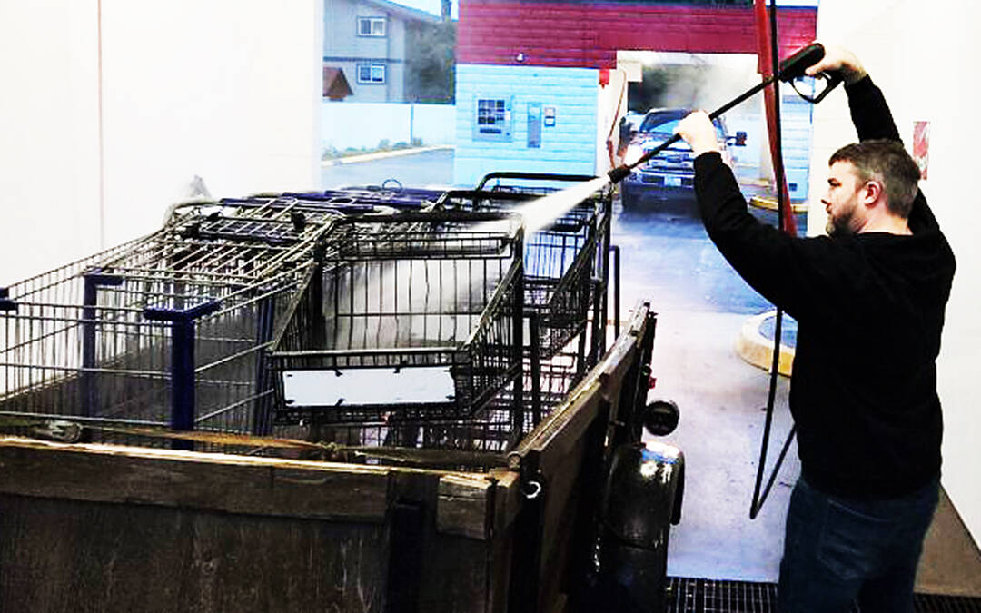 Sponsor-A-Can courtesy photos
Matthew Boisson uses a car wash hose to spray off multiple carts in the back of a truck.