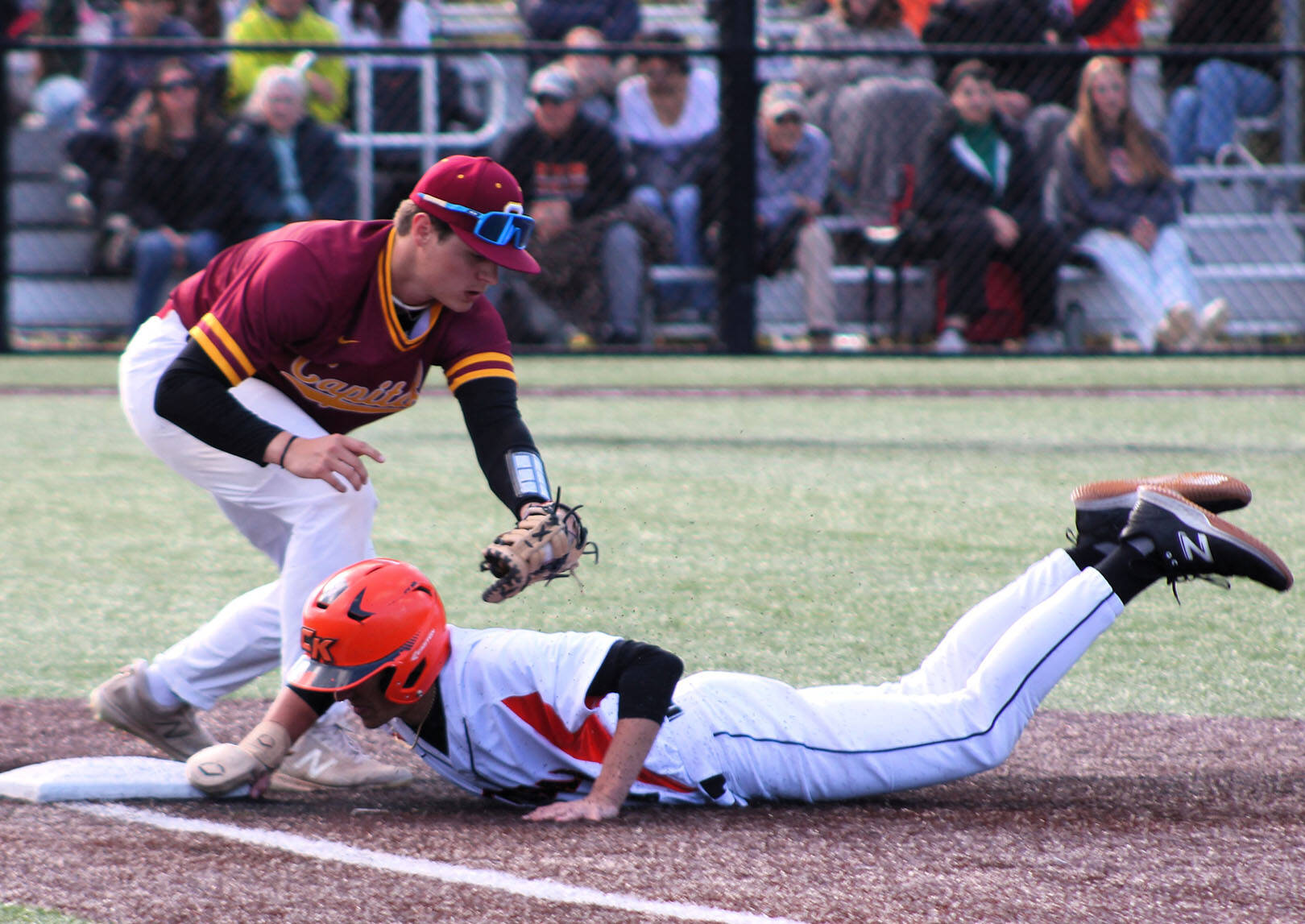 Elisha Meyer/Kitsap News Group
Tanner Herdman of Central Kitsap dives back to first base on a pickoff attempt.