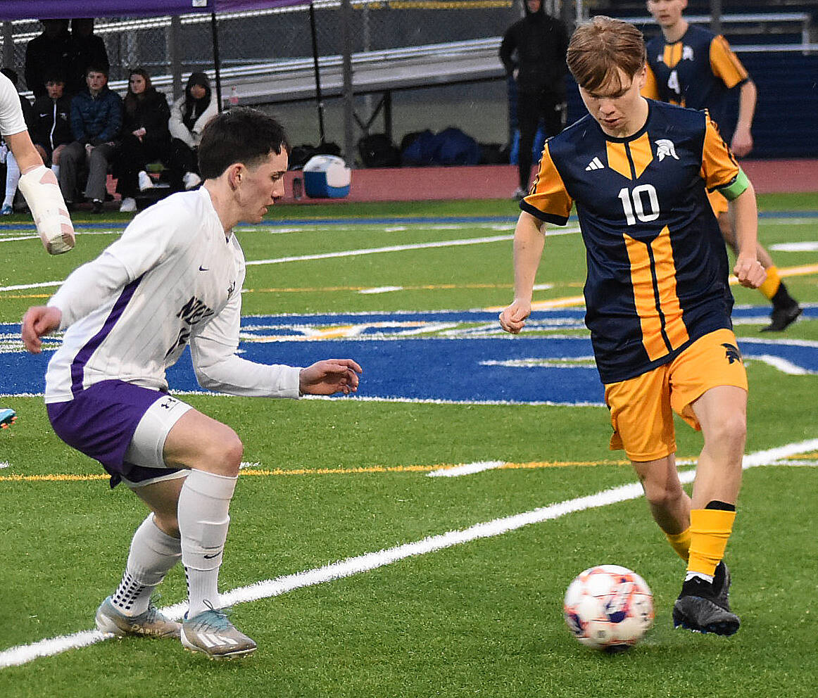 File photos
Spartan Christopher Fowler dribbles past defenders.