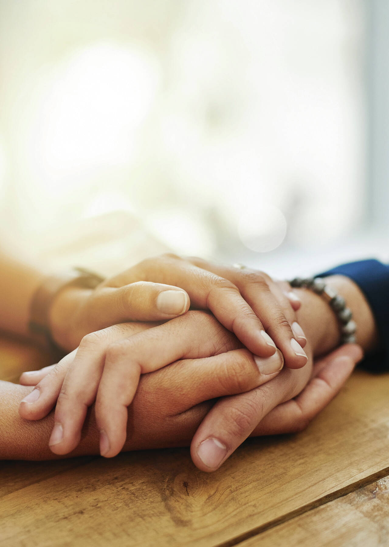 Closeup shot of two unrecognizable people holding hands in comfort