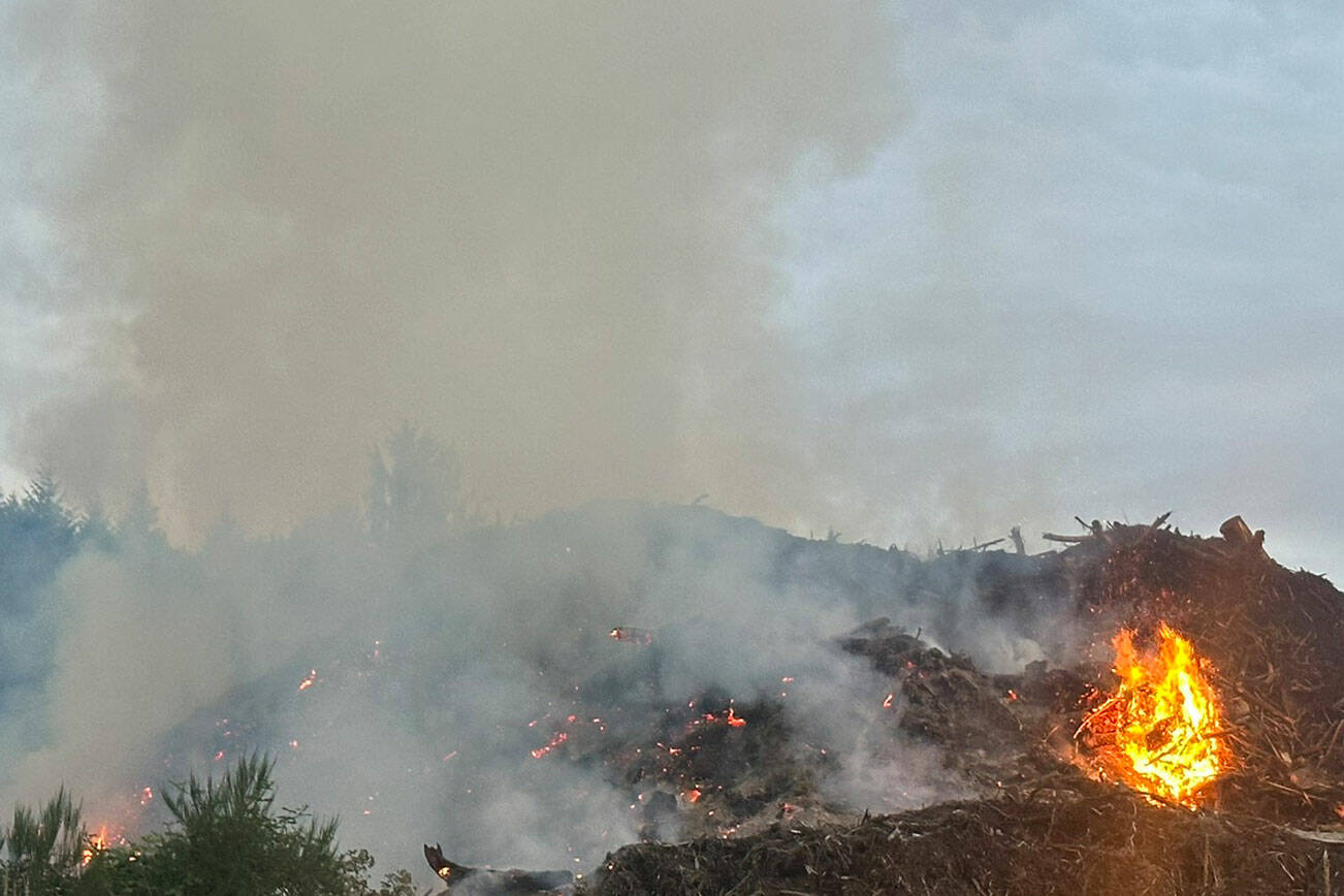 NKF&R courtesy photo
Smoke will be visible in some parts of North Kitsap for at least a day as natural woody debris continues to burn after it caught fire at A&L Topsoil the early morning of July 19.