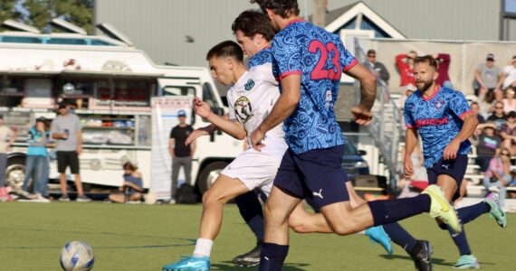 Elisha Meyer/Kitsap News Group photos
POFC’s Michael Divano fights to make his way downfield in the first half of the CPL1 title match.