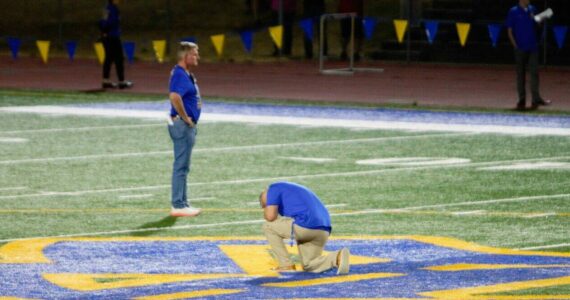 File photo
Former assistant football coach Joe Kennedy prays at midfield in his first and only game back on the coaching staff at Bremerton High School in 2023. He resigned just days later.