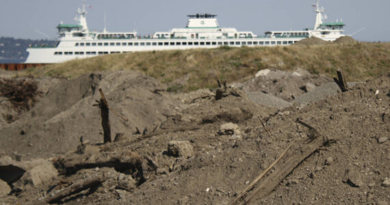 Molly Hetherwick/Kitsap News Group photos
A few large piles of creosote-contaminated dirt frame the future view from Pritchard Park, while a ferry arrives in Bainbridge.