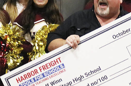 Harbor Freight courtesy photo
South Kitsap High School trades teacher Jeff Winn celebrates receiving a check for $100,000 for himself and his school program Oct. 8.