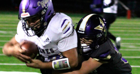 Elisha Meyer/Kitsap News Group photos
NK freshman Townsyn Walsh wraps up a Sequim wideout in the first half of the game Oct. 10.