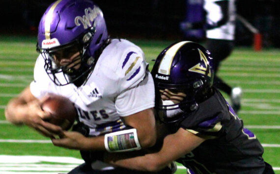 Elisha Meyer/Kitsap News Group photos
NK freshman Townsyn Walsh wraps up a Sequim wideout in the first half of the game Oct. 10.