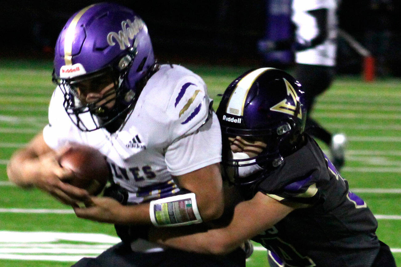 Elisha Meyer/Kitsap News Group photos
NK freshman Townsyn Walsh wraps up a Sequim wideout in the first half of the game Oct. 10.