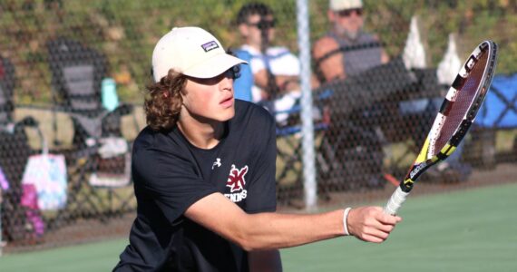 Elisha Meyer/Kitsap News Group photos
SK senior Sam Colson goes low to get his racket on the ball.