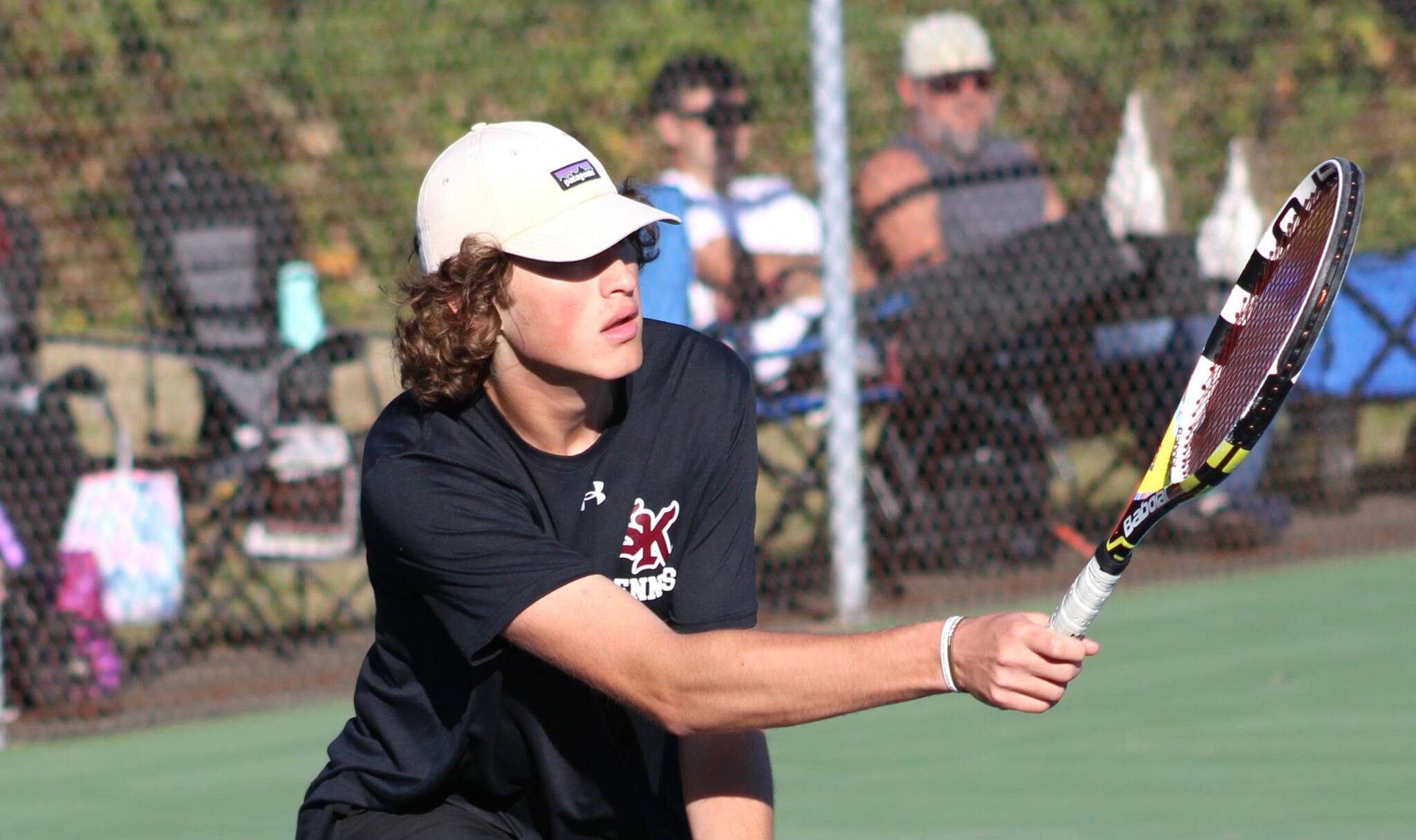 Elisha Meyer/Kitsap News Group photos
SK senior Sam Colson goes low to get his racket on the ball.