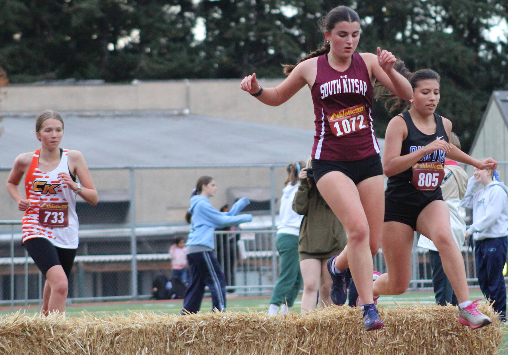 Elisha Meyer/Kitsap News Group photos
Runners in all races at the Hawk’s Nest Invitational came across the occasional hurdle of hay, a fun part of the speedy 3,000-meter course.