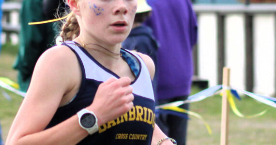 Elisha Meyer/Kitsap News Group
Junior Savai Esarey crosses the finish line at her team’s home course at Battle Point Park on Bainbridge Island Oct. 18.