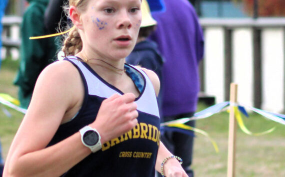 Elisha Meyer/Kitsap News Group
Junior Savai Esarey crosses the finish line at her team’s home course at Battle Point Park on Bainbridge Island Oct. 18.