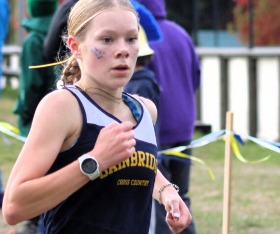 Elisha Meyer/Kitsap News Group
Junior Savai Esarey crosses the finish line at her team’s home course at Battle Point Park on Bainbridge Island Oct. 18.