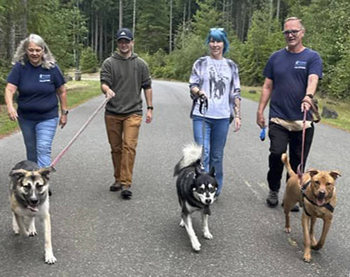 KHS courtesy photos
Community members take KHS dogs out for a walk through the ‘Barks and Recs’ program.