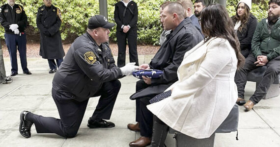 Bergeron family courtesy photos
Bill Bergeron Jr. receives a U.S. flag at a military funeral for his father.