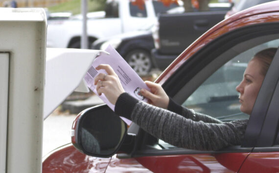 Molly Hetherwick/Kitsap News Group
A voter puts her election ballot in a drop box on Bainbridge Island Nov. 5.