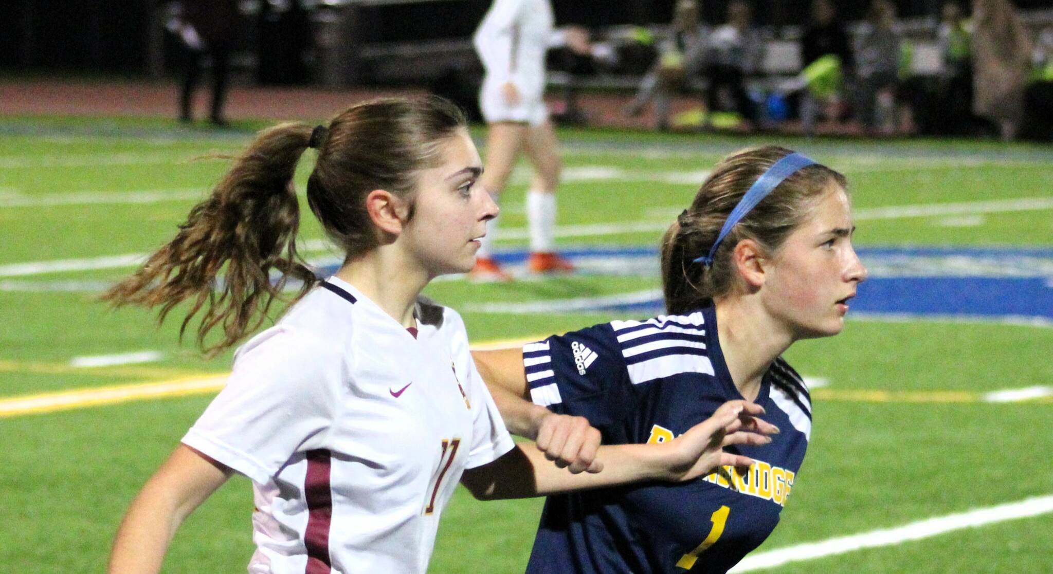 Elisha Meyer/Kitsap News Group photos
Kingston sophomore Emily Kispert and Bainbridge freshman Vega Hendrickson battle for better ground while watching the ball.