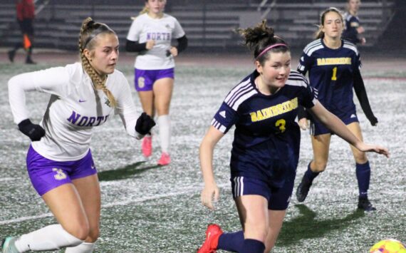 Elisha Meyer/Kitsap News Group
North Kitsap senior Andrea Zetty and Bainbridge junior Izzi Pujolar chase down the ball in the second half of the district championship match.