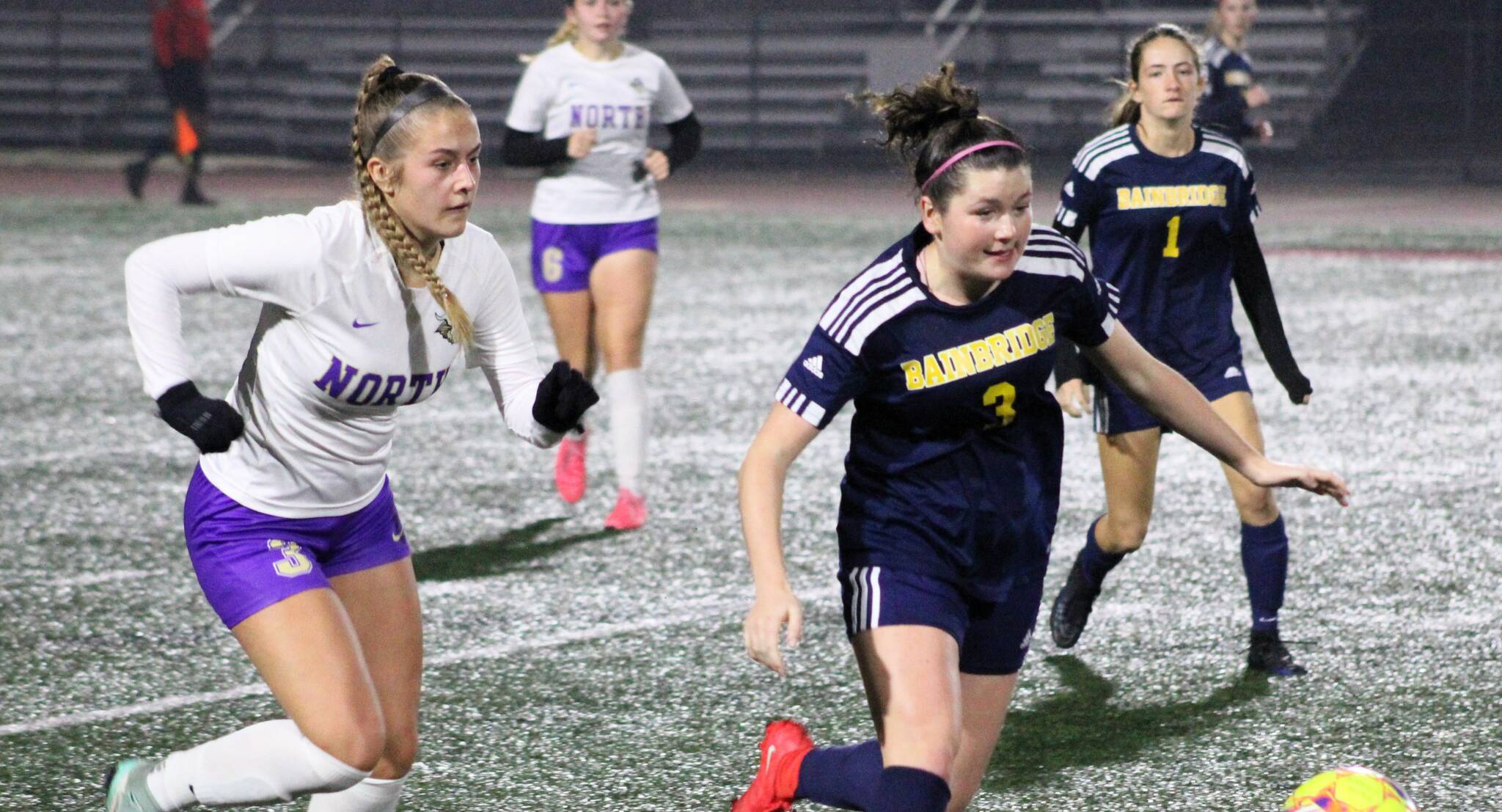 Elisha Meyer/Kitsap News Group
North Kitsap senior Andrea Zetty and Bainbridge junior Izzi Pujolar chase down the ball in the second half of the district championship match.