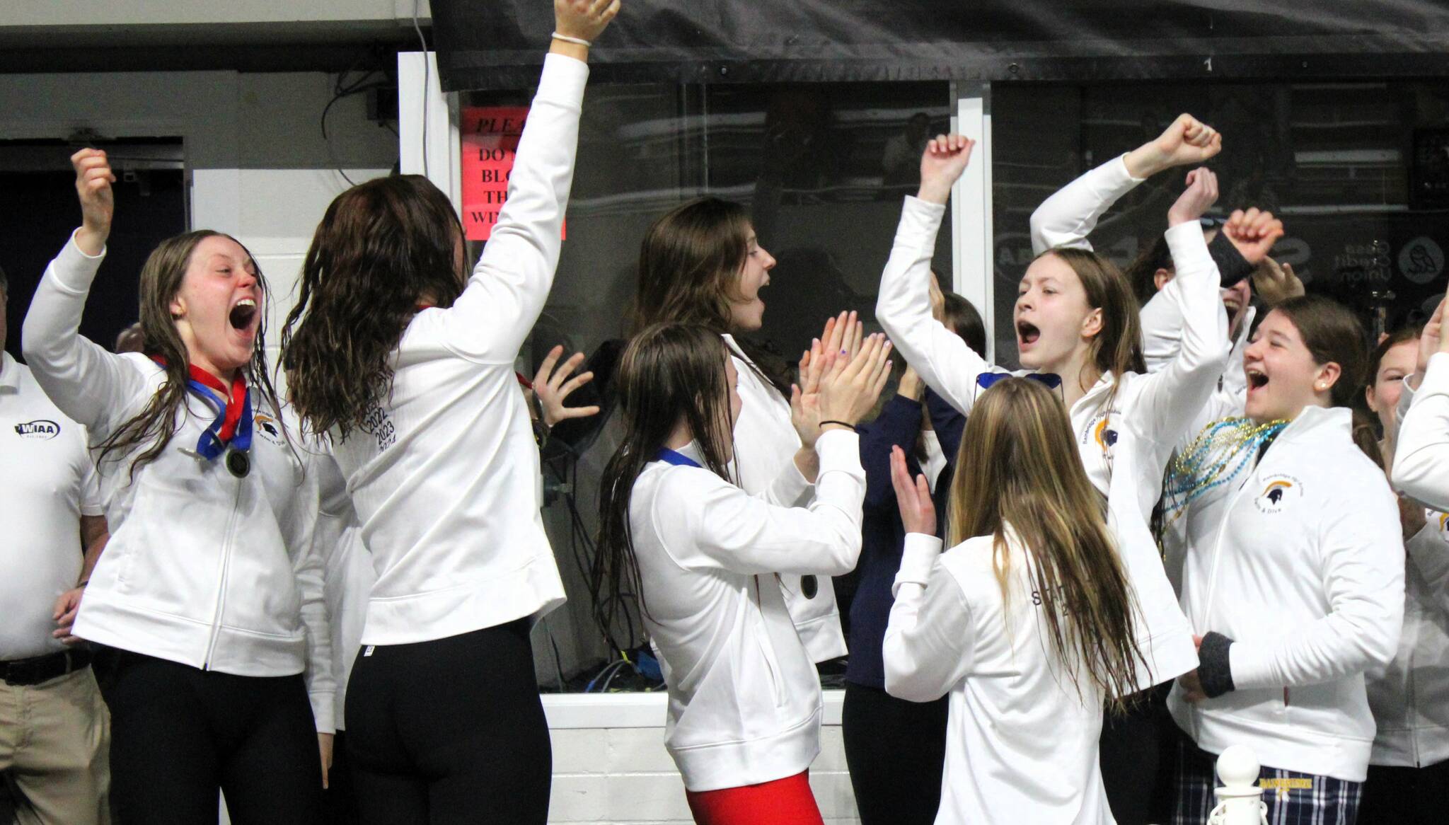 Elisha Meyer/Kitsap News Group photos
 Bainbridge swimmers rejoice after officials announce the Spartans won their first WIAA state championship since 2021.