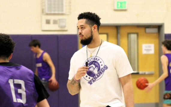 Elisha Meyer/Kitsap News Group 
NK coach Shaa Humphrey runs his players through conditioning at the start of practice.