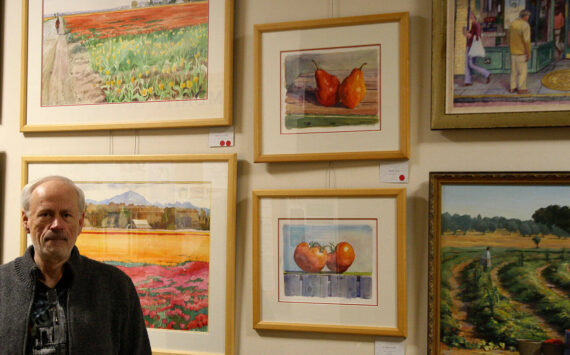 Tyler Shuey/Kitsap News Group photos
Local artist Kim Drew stands next to some of his artwork at the Village Green Community Center in Kingston, which will be on display through Dec. 26.