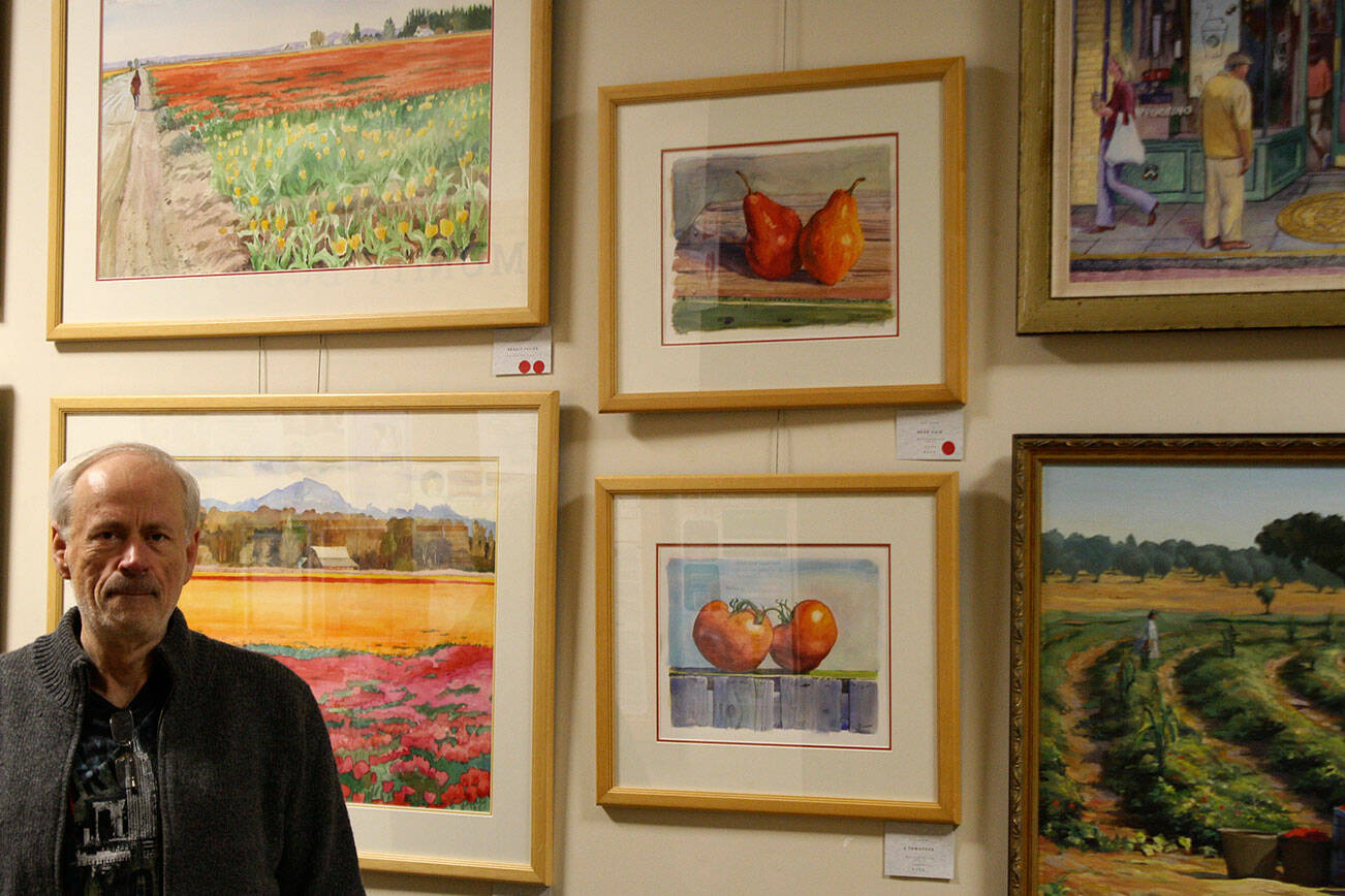 Tyler Shuey/Kitsap News Group photos
Local artist Kim Drew stands next to some of his artwork at the Village Green Community Center in Kingston, which will be on display through Dec. 26.