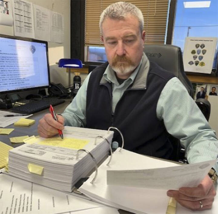 Mike De Felice/Kitsap News Group
Sgt. Jason Vertefeuille of the Bremerton Police Department pours over reports of stolen vehicles in Kitsap County and looks for trends. His work has dramatically reduced the number of such thefts.