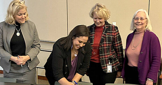 PGST courtesy photo
PGST Chairwoman Amber Caldera signs the agreement alongside the Kitsap County Commissioners Nov. 25.