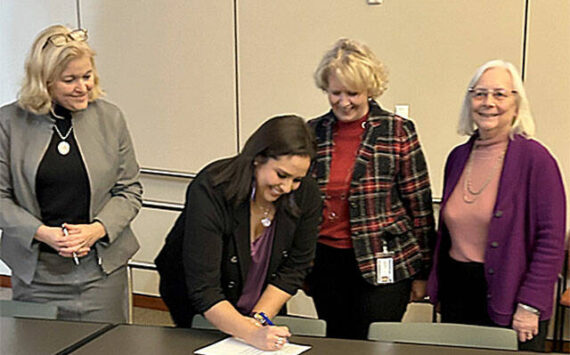 PGST courtesy photo
PGST Chairwoman Amber Caldera signs the agreement alongside the Kitsap County Commissioners Nov. 25.