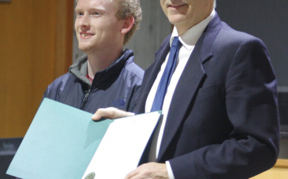 Molly Hetherwick/Kitsap News Group
Tyler Shuey of the Review, left, accepts a proclamation from BI Mayor Joe Deets declaring Dec. 10 ‘Bainbridge Island Review Day’ in honor of the newspaper’s 100th anniversary.