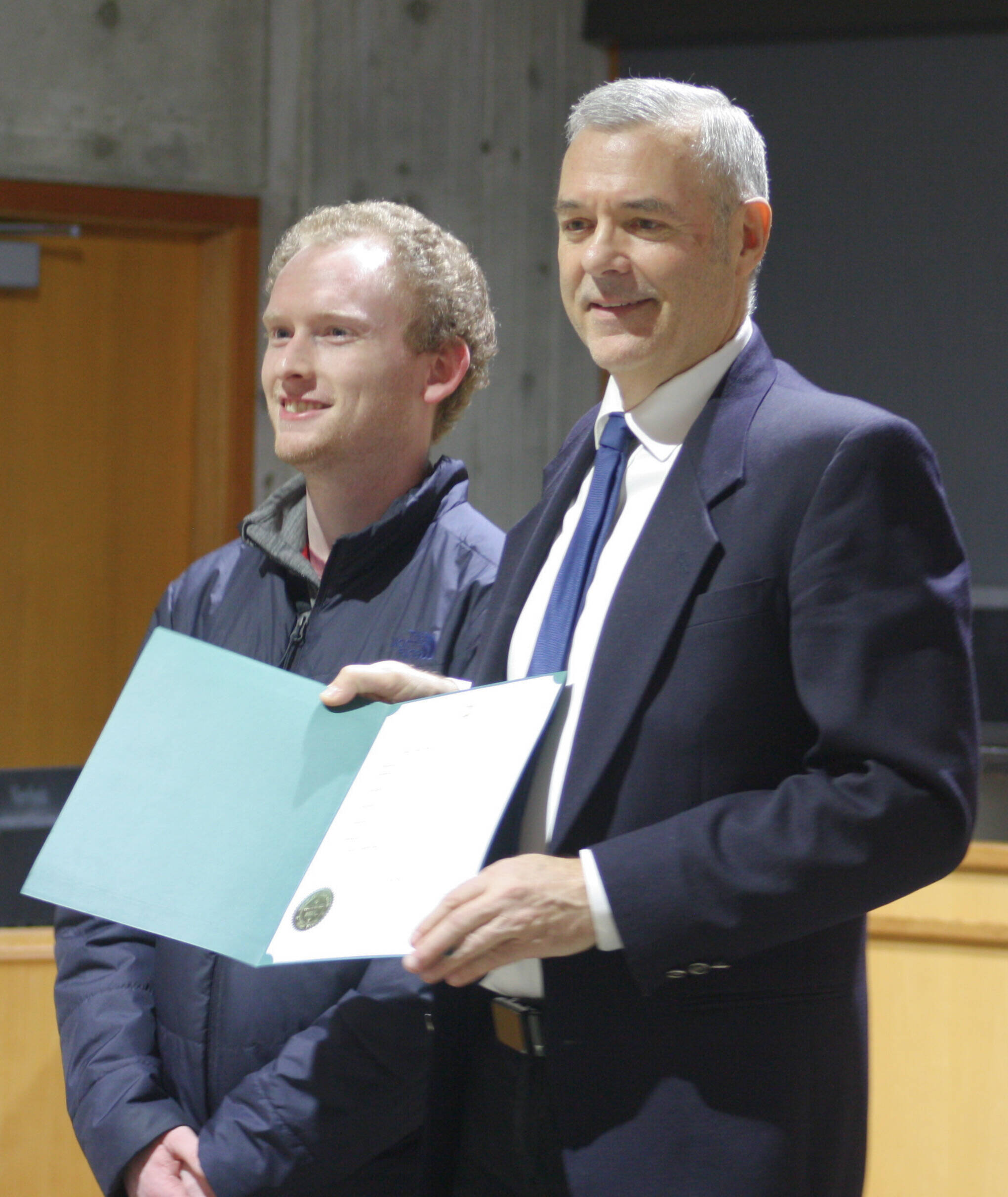 Molly Hetherwick/Kitsap News Group
Tyler Shuey of the Review, left, accepts a proclamation from BI Mayor Joe Deets declaring Dec. 10 ‘Bainbridge Island Review Day’ in honor of the newspaper’s 100th anniversary.